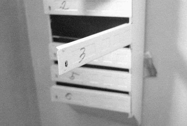 A black-and-white photograph of a partly open numbered drawer.